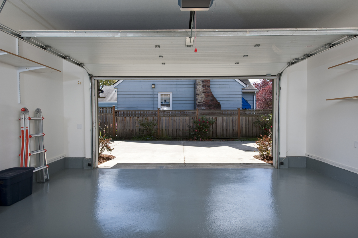 Open the garage door leading out to a driveway