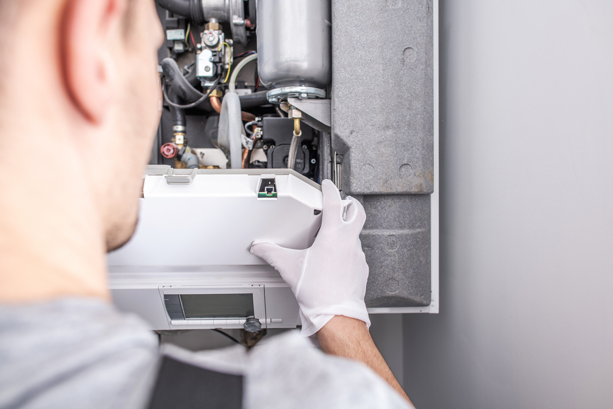 Blue Frost HVAC technician repairing a residential furnace