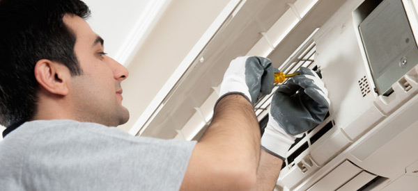 HVAC technician repairing a ductless mini-split