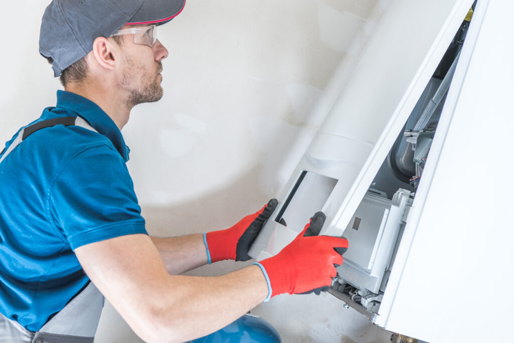 Illinois HVAC technician installing a furnace in Rolling Meadows